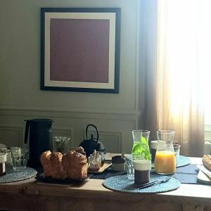 a table with breakfast foods and drinks on it at la maison haute in Toucy