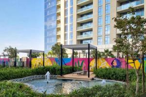 a pool of water in front of a building at Aykon City 2 bedroom Burj view in Dubai