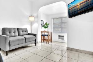 a living room with a couch and a table at Downtown Hollywood Beach Blvd Studio Getaway in Hollywood
