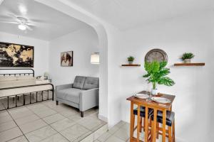 a living room with a couch and a table at Downtown Hollywood Beach Blvd Studio Getaway in Hollywood +34 photos