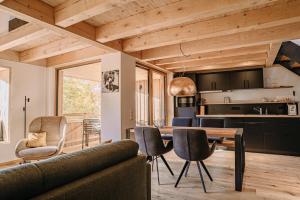 a kitchen and living room with a table and chairs at Mächlerhof in Stötten am Auerberg
