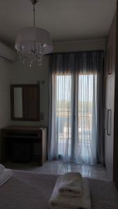 a bedroom with a bed and a large window at Ioanna Apartment 2 in Chania Town