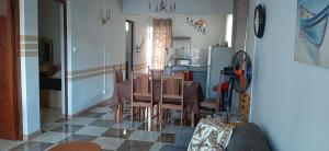 a dining room with a table and a kitchen at Ground Floor Lovely two bedrooms apartment in Flic-en-Flac