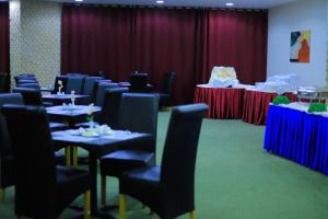 a conference room with tables and chairs and tablesktop at Delmar Hotel Matrouh in Marsa Matruh