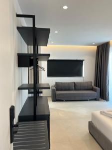 a living room with a couch and a black shelf at Adele Hotel Ksamil in Ksamil