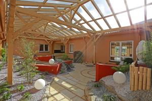 a large patio with a large wooden structure with at Hotel Falkenhagen in Pritzwalk +3 photos