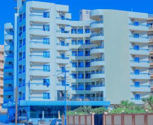 a tall blue apartment building with blue balconies at Delmar Hotel Matrouh in Marsa Matruh