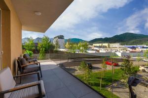 a balcony with chairs and a view of a city at Mountain View Terrace Oasis with Parking and AC in Braşov