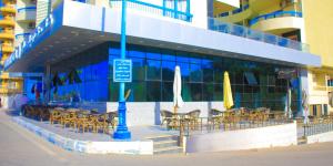 a group of chairs and umbrellas in front of a building at Delmar Hotel Matrouh in Marsa Matruh