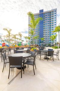 Salinas Exclusive Resort في سالينوبوليس: فناء به طاولات وكراسي ومبنى