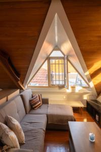 a living room with a couch and a window at Neoclassical Mytilene - Vournazon 17 in Mytilini