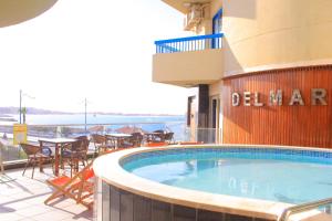 a large swimming pool on the side of a building at Delmar Hotel Matrouh in Marsa Matruh