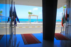 a view of the beach from a building with flags at Delmar Hotel Matrouh in Marsa Matruh