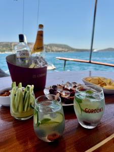 a table with two glasses of water and some food at Usta-k in Bodrum City
