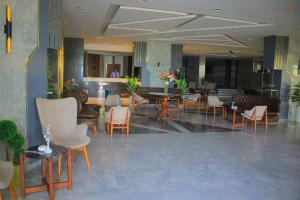a lobby with chairs and tables in a building at Delmar Hotel Matrouh in Marsa Matruh