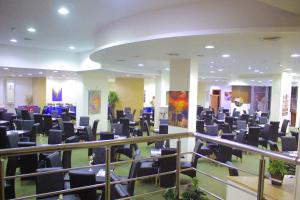 a large room with black chairs in a building at Delmar Hotel Matrouh in Marsa Matruh