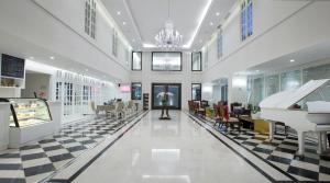 a mall with a grand piano and a checkerboard floor at Hotel Santika Seminyak in Seminyak