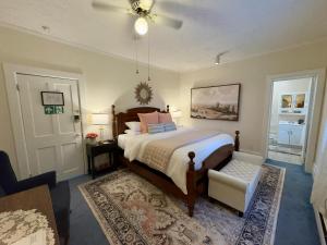 a bedroom with a bed and a ceiling fan at Victorian Inn Bed And Breakfast in Marblehead