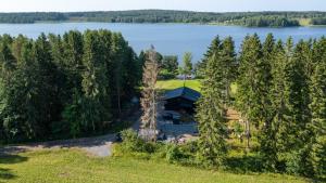 an aerial view of a cabin in the woods next to a lake at Villa Rantaniitty in Tampere