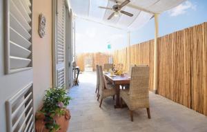 a dining room with a table and chairs on a patio at 3 Bedroom Gorgeous Home In Viareggio in Viareggio +21 photos