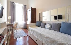 a living room with a large couch with blue pillows at 3 Bedroom Gorgeous Home In Viareggio in Viareggio