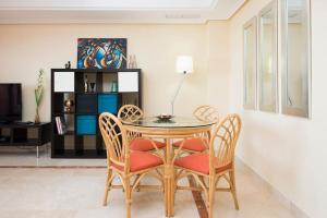 a dining room with a table and chairs at Luxury apartment with sea views, golf, gym, spa, 7 pools in Ojén