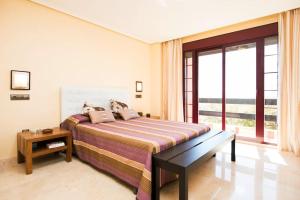 a bedroom with a bed and a large window at Luxury apartment with sea views, golf, gym, spa, 7 pools in Ojén +33 photos