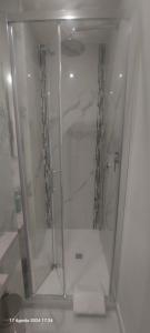 a shower with a glass door in a bathroom at Bemy in Rome