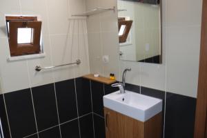 a bathroom with a sink and a mirror at Huzur Pansiyon in Çanakkale +35 photos