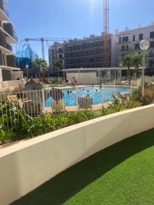 a view of a swimming pool behind a fence at Casa Verde Dénia in Denia