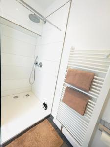 a bathroom with a shower with a towel at Innerste City Getaway in Goslar +8 photos