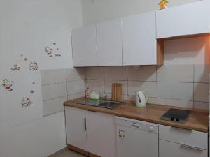 a kitchen with white cabinets and a counter top at Guest house Renata 2 in Zadar