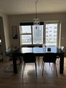 a dining table and chairs in a living room at Comfy flat in Kópavogur in Reykjavík +1 photo