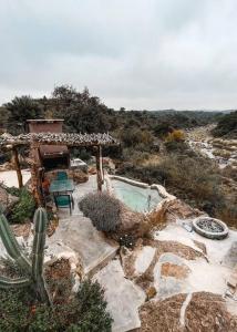 ビージャ・クーラ・ブロチェロにあるCueva de lujo con rio de montaña Casa cuevaの裏庭(スイミングプール、サボテン付)