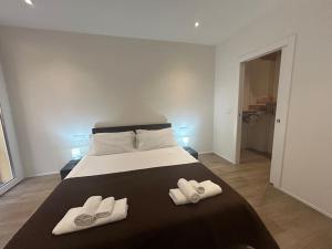 a bedroom with a bed with two slippers on it at Ariosti 3 - Piazza Maggiore in Bologna +18 photos