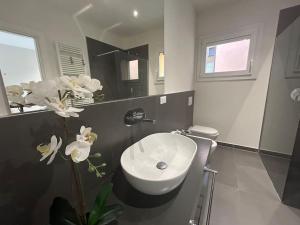 a bathroom with a white sink and a toilet at Ariosti 3 - Piazza Maggiore in Bologna