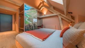 a bedroom with a bed with a large window at Domaine Carrel & Senger in Jongieux