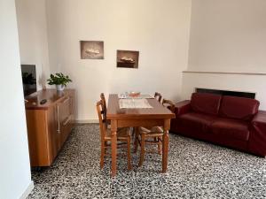 a living room with a table and a couch at Casa Vacanze Tra gli Olivi in Bonarcado