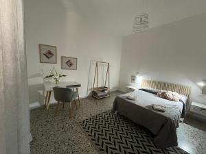 a bedroom with a bed and a desk and a chair at Casa Vacanze Tra gli Olivi in Bonarcado