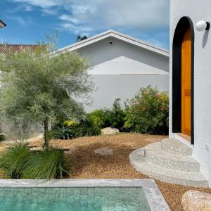 a house with a swimming pool in front of a yard at Breath Private Pool Villa Kohlarn in Ko Larn