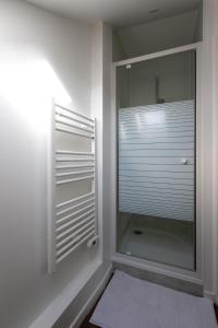 a walk in shower with a glass door in a bathroom at Studio Duplex in Montargis