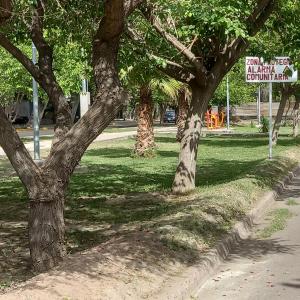 un grupo de árboles en un parque con un cartel en Verdes montañas, en Villa Nueva