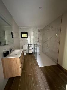 a large bathroom with a sink and a shower at Chapelle Blóm in Nougaroulet