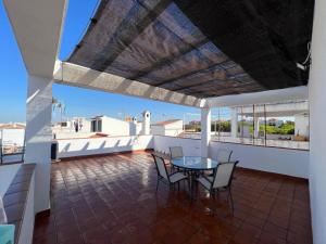 a balcony with a table and chairs on it at Seaside Paradise Mazagon in Mazagón