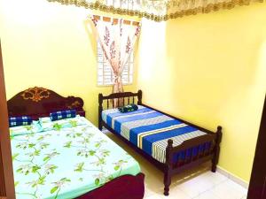 Кровать или кровати в номере Lavender Homestay Tanjung Malim