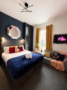 a bedroom with a bed and a couch at A&A Luxury Stay Rosedale St - Chic, Modern, City Centre, Neon Decor in Sunderland