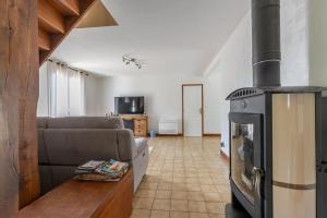 a living room with a stove in the middle of it at L'Ozormo - Climatisée - Maison - Jardin in Amboise