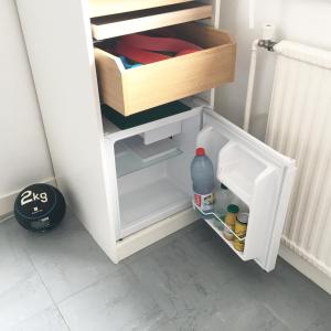 a small white refrigerator with its door open at Bed and Breakfast Nantes au calme proche aéroport, gare et centre-ville in Saint-Sébastien-sur-Loire