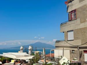a building with a view of the ocean and aominium at Sweet Home in Vico Equense