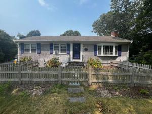 a white house with a wooden fence at 177 Old Stage Road Centerville - - Family Tides in Centerville